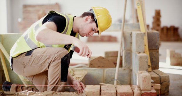 A photo of a student at Northumberland College Ashington Campus, laying bricks
