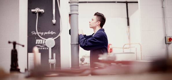 A plumbing student at Sunderland College, fixing a pipe