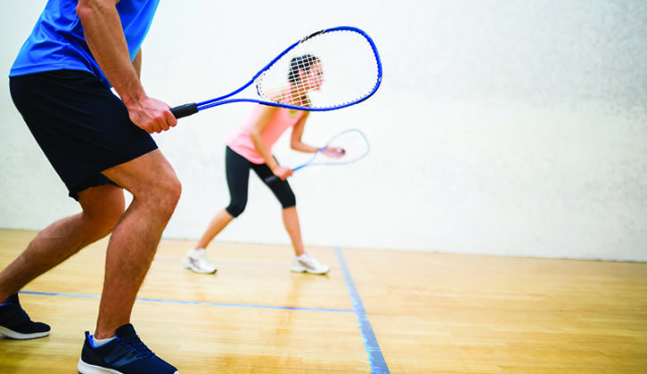 Two people playing tennis in a sports hall at Northumberland College