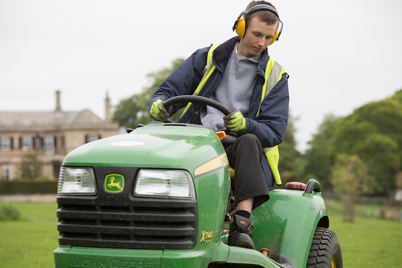 A student at Northumberland College, safely using tools