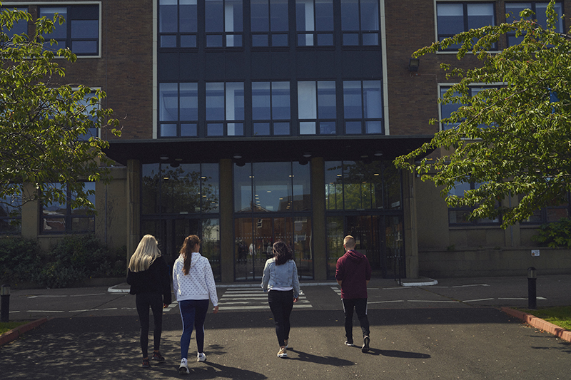 4 students walking towards Ashington Campus at Northumberland College