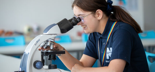A student using a microscope at Northumberland College