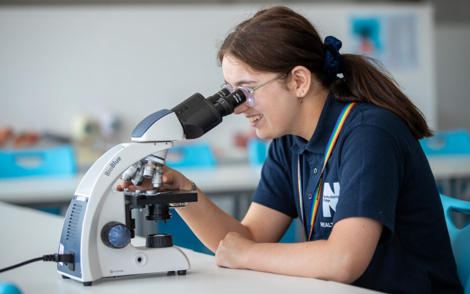 A student using a microscope at Northumberland College