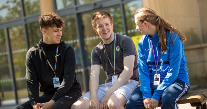 Three students smiling and laughing outside of Ashington Campus at Northumberland College